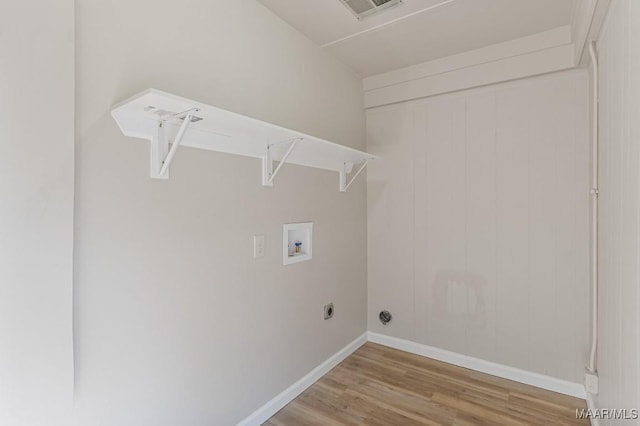 clothes washing area with visible vents, light wood finished floors, baseboards, hookup for a washing machine, and laundry area