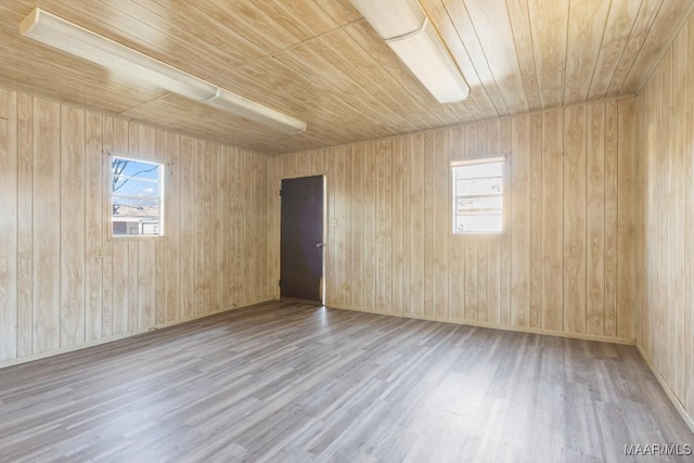 empty room featuring wood ceiling and wood finished floors