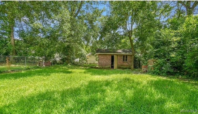 view of yard with an outbuilding, a fenced backyard, and a storage shed