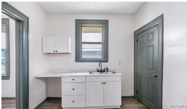 bathroom with vanity, baseboards, and wood finished floors