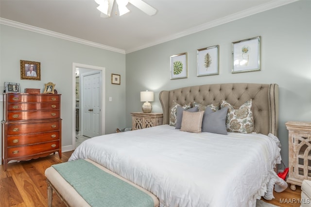 bedroom featuring ceiling fan, wood finished floors, and crown molding