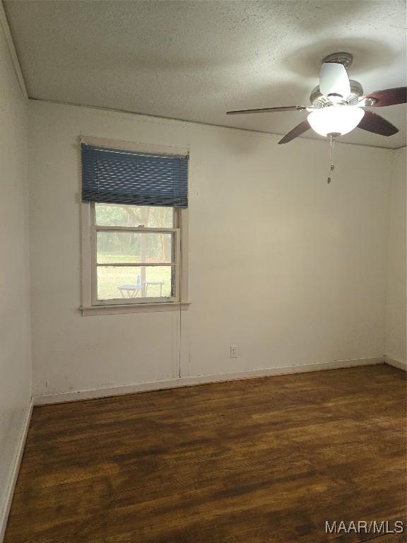 empty room with a ceiling fan, wood finished floors, and a textured ceiling