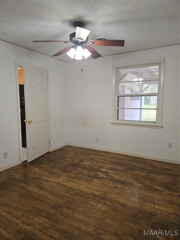 spare room featuring baseboards, a textured ceiling, ceiling fan, and wood finished floors