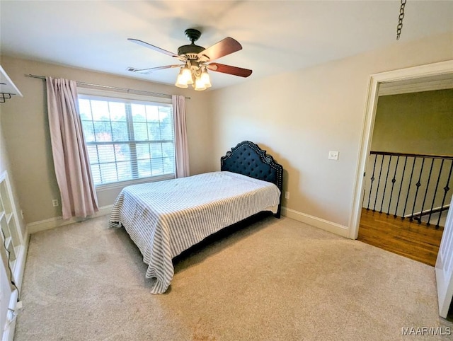 carpeted bedroom featuring visible vents, baseboards, and ceiling fan