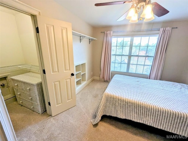 bedroom featuring light colored carpet and a ceiling fan