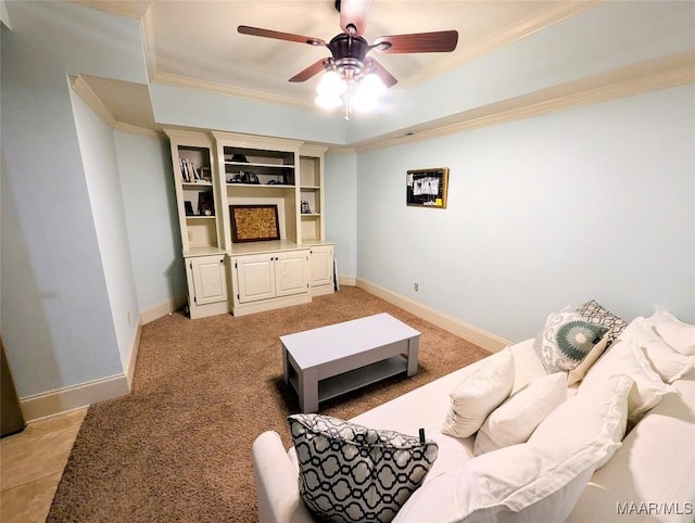 living area with light carpet, baseboards, a ceiling fan, and ornamental molding