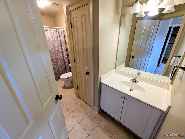 bathroom with tile patterned floors, visible vents, toilet, and vanity