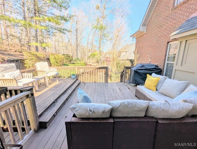 wooden terrace with area for grilling and an outdoor hangout area