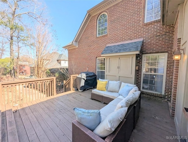 wooden deck featuring an outdoor living space and area for grilling