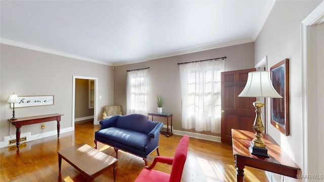 living area featuring visible vents, baseboards, wood finished floors, and ornamental molding