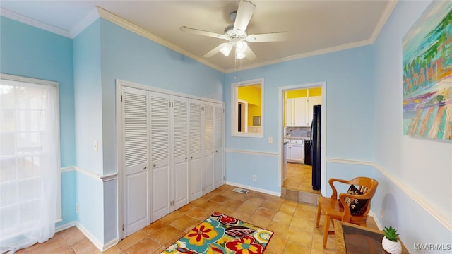 interior space with visible vents, freestanding refrigerator, a closet, crown molding, and light tile patterned floors