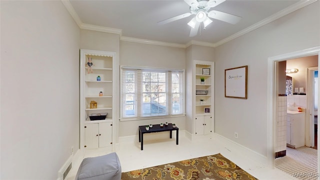 sitting room with ornamental molding, baseboards, and ceiling fan