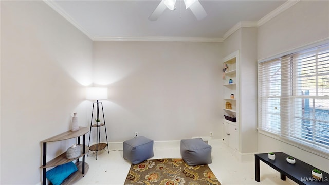 sitting room with crown molding, built in shelves, a ceiling fan, and baseboards