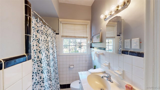 bathroom featuring a shower with shower curtain, tile walls, toilet, and vanity