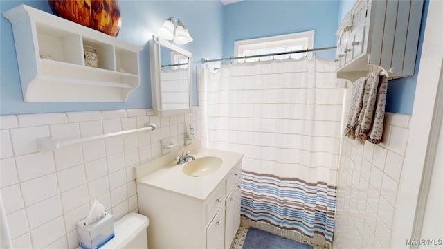 full bathroom with vanity, tile walls, and curtained shower