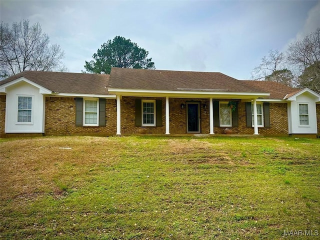 ranch-style house with a front yard, brick siding, and a shingled roof