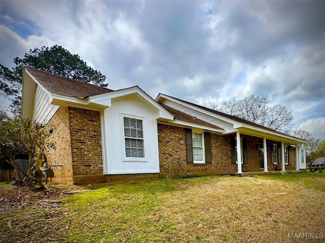 ranch-style home with brick siding and a front yard