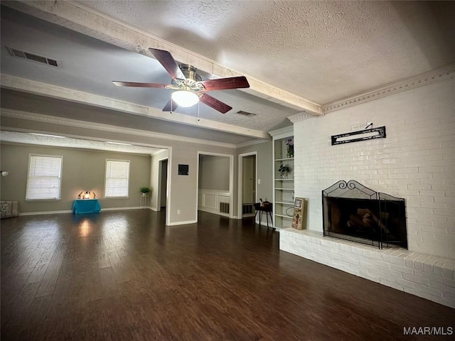 unfurnished living room with visible vents, ceiling fan, beamed ceiling, wood finished floors, and a textured ceiling