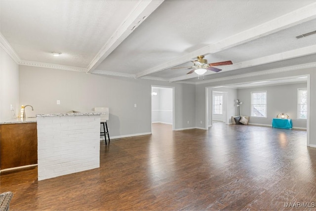 29 Creek Dr, Montgomery, AL 36117 - unfurnished living room with visible vents, beam ceiling, a ceiling fan, wood finished floors, and baseboards