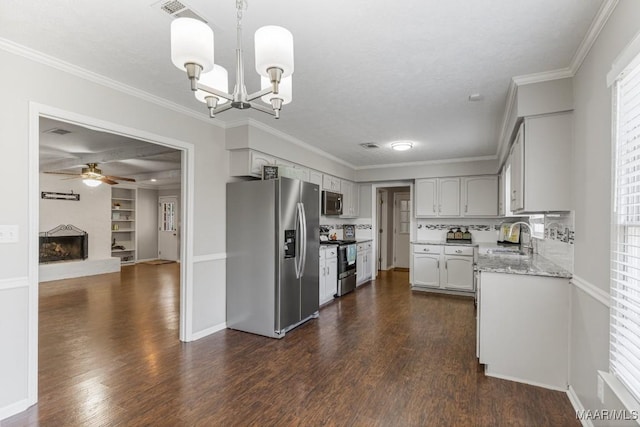 29 Creek Dr, Montgomery, AL 36117 - kitchen with dark wood-type flooring, ceiling fan with notable chandelier, a sink, stainless steel appliances, and crown molding