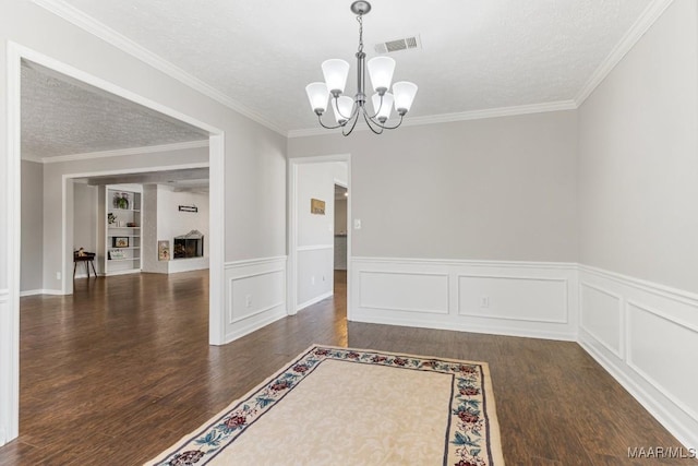29 Creek Dr, Montgomery, AL 36117 - empty room with visible vents, a textured ceiling, an inviting chandelier, and wood finished floors