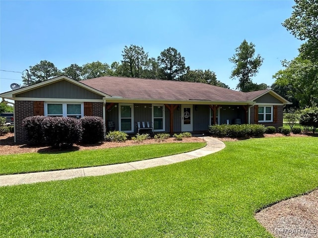 ranch-style home featuring brick siding and a front lawn