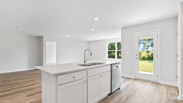 3140 Knotts Dr, Montgomery, AL 36116 - kitchen with dishwasher, light wood finished floors, light countertops, a kitchen island with sink, and recessed lighting
