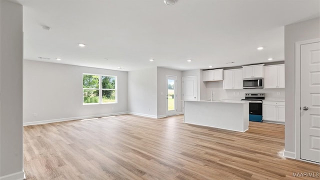 3140 Knotts Dr, Montgomery, AL 36116 - kitchen featuring appliances with stainless steel finishes, open floor plan, light wood-style floors, white cabinetry, and recessed lighting
