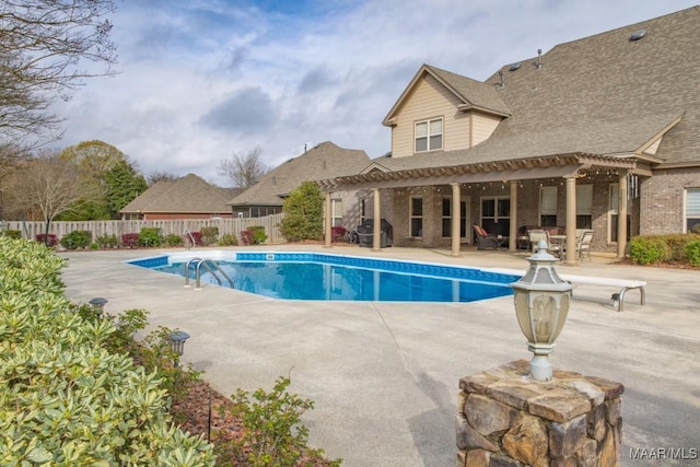 view of swimming pool with a fenced in pool, a pergola, a patio, and fence