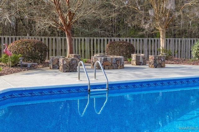 view of pool with a fenced in pool, a patio, and fence