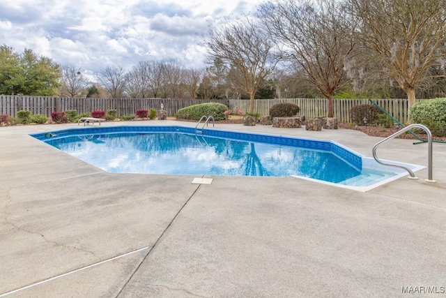 view of swimming pool with a patio area and a fenced backyard