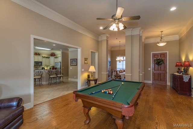 game room with light wood-type flooring, pool table, crown molding, and ceiling fan with notable chandelier