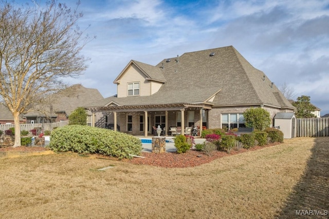 back of house with an outbuilding, fence, a pergola, a storage shed, and a patio area