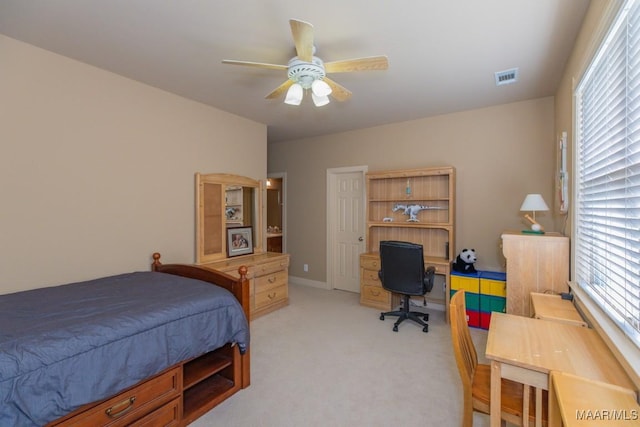 bedroom featuring visible vents, light carpet, and a ceiling fan