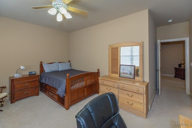 bedroom with a ceiling fan and light colored carpet