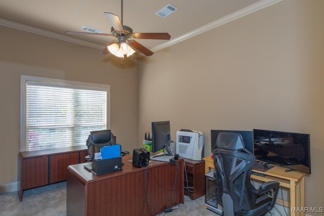 home office with crown molding, a ceiling fan, visible vents, and light carpet