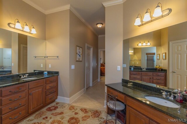 bathroom with tile patterned floors, ornamental molding, baseboards, and a sink