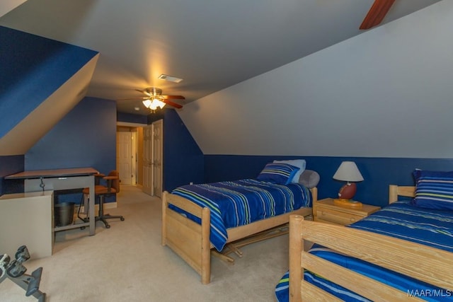 carpeted bedroom featuring visible vents, lofted ceiling, and a ceiling fan