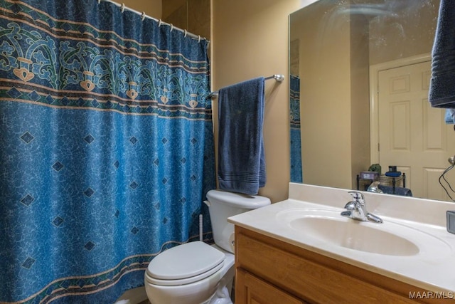 bathroom featuring curtained shower, toilet, and vanity