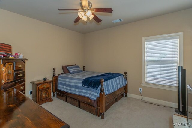 bedroom featuring ceiling fan, carpet, visible vents, and baseboards