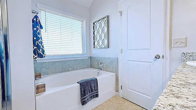 bathroom featuring tile patterned floors and a garden tub