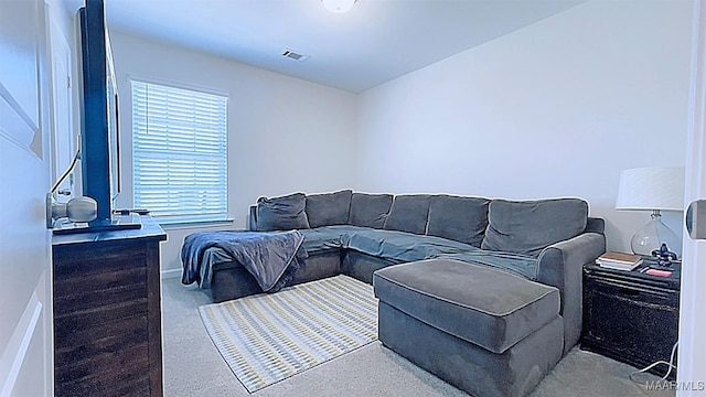 living room featuring baseboards and visible vents