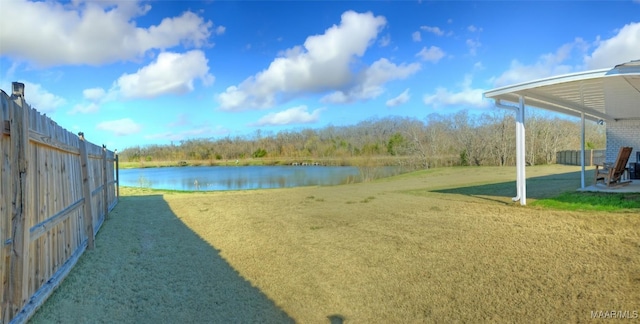 view of yard featuring fence and a water view