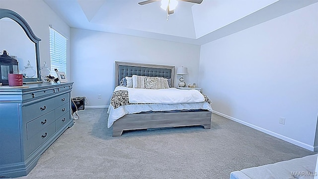 bedroom featuring baseboards, a raised ceiling, ceiling fan, and carpet flooring