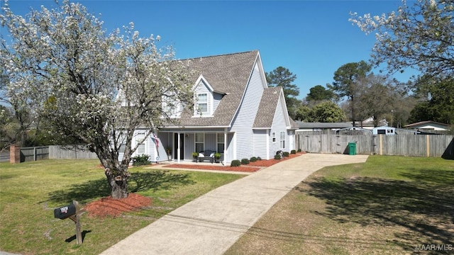 cape cod-style house featuring a gate, a shingled roof, a front yard, and fence