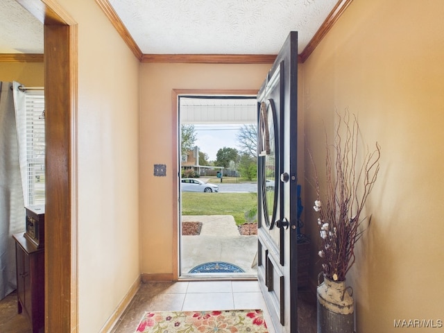 foyer entrance with light tile patterned floors, baseboards, a textured ceiling, and ornamental molding