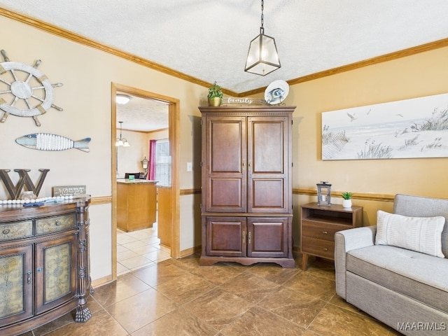 living area featuring tile patterned flooring, a textured ceiling, baseboards, and ornamental molding