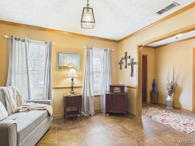 living area featuring a wealth of natural light, visible vents, a textured ceiling, and crown molding