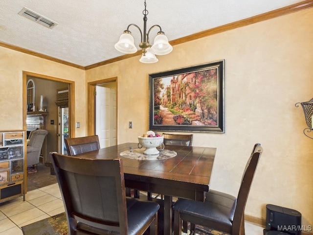 dining area featuring visible vents, a notable chandelier, crown molding, and a textured ceiling