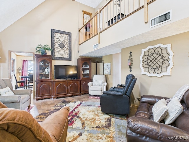 living room with a high ceiling and visible vents